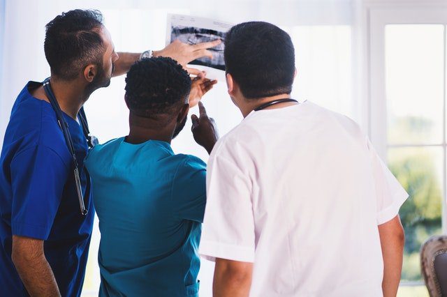 doctors looking at xray of injury